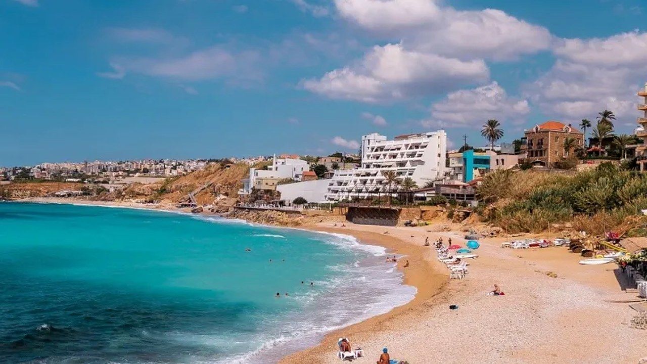 Turquoise water and sandy shoreline at Al Bahsa Beach in Byblos