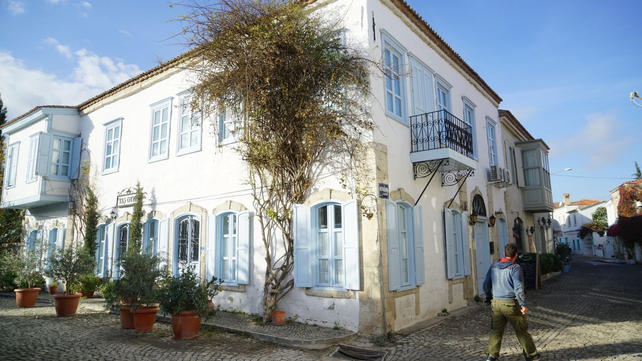 Charming historic street with whitewashed houses and cobblestone paths in Alacati, Izmir, Turkey.