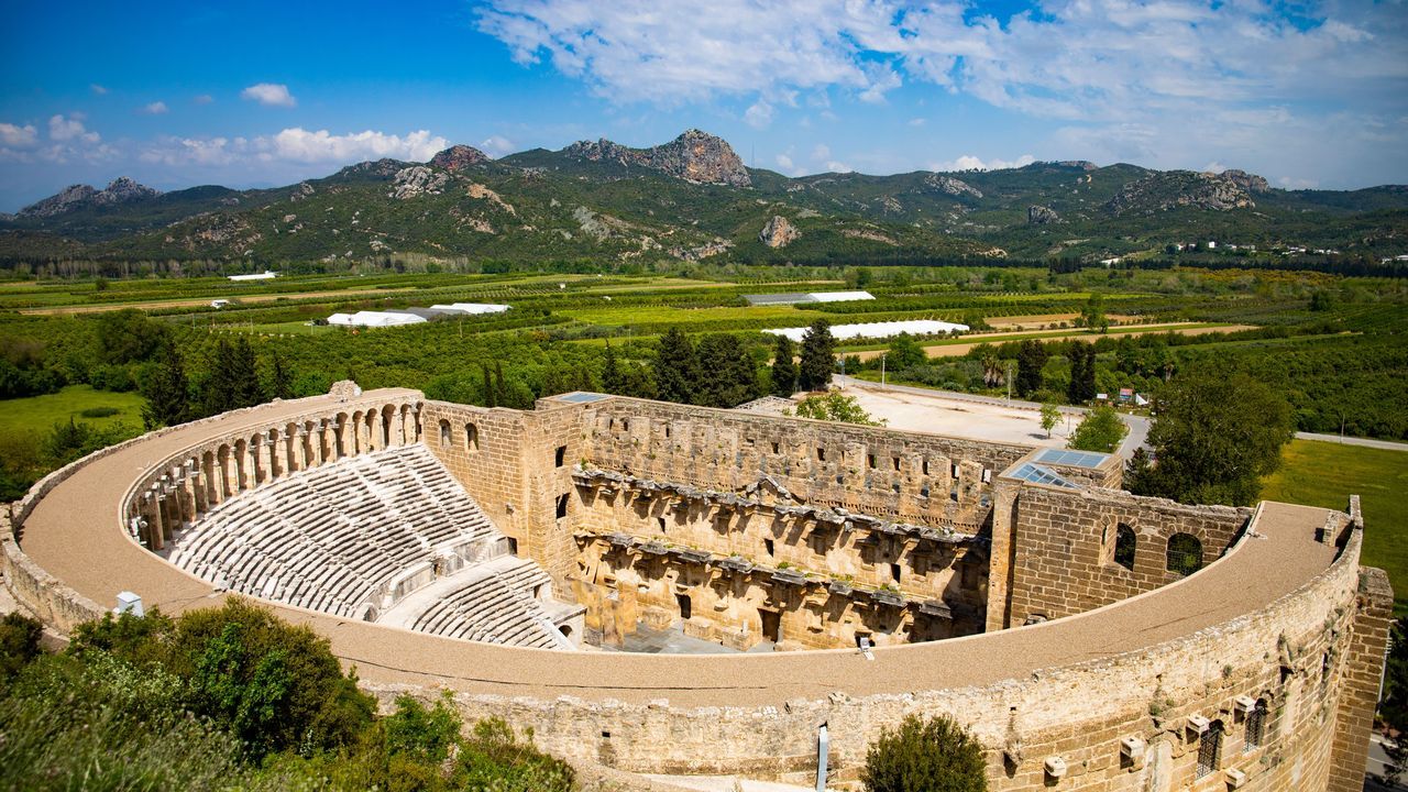 Wide view of Aspendos Theatre in Antalya with the ancient Roman amphitheater and surrounding mountains