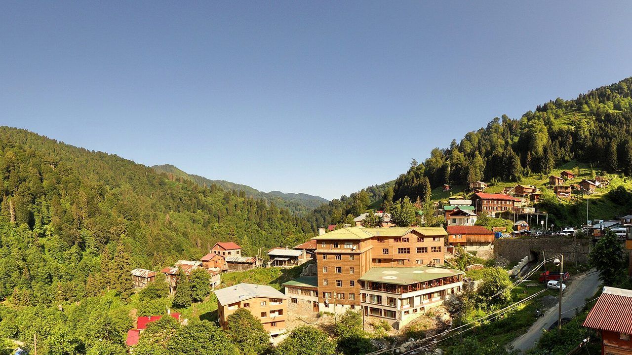 Wide panoramic view of Ayder Plateau surrounded by forested mountains in Rize