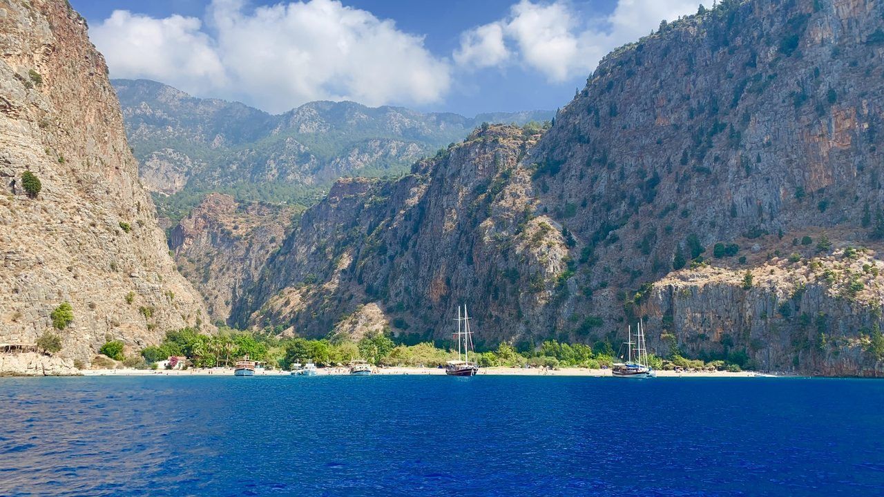 Butterfly Valley beach surrounded by dramatic cliffs and turquoise water in Fethiye