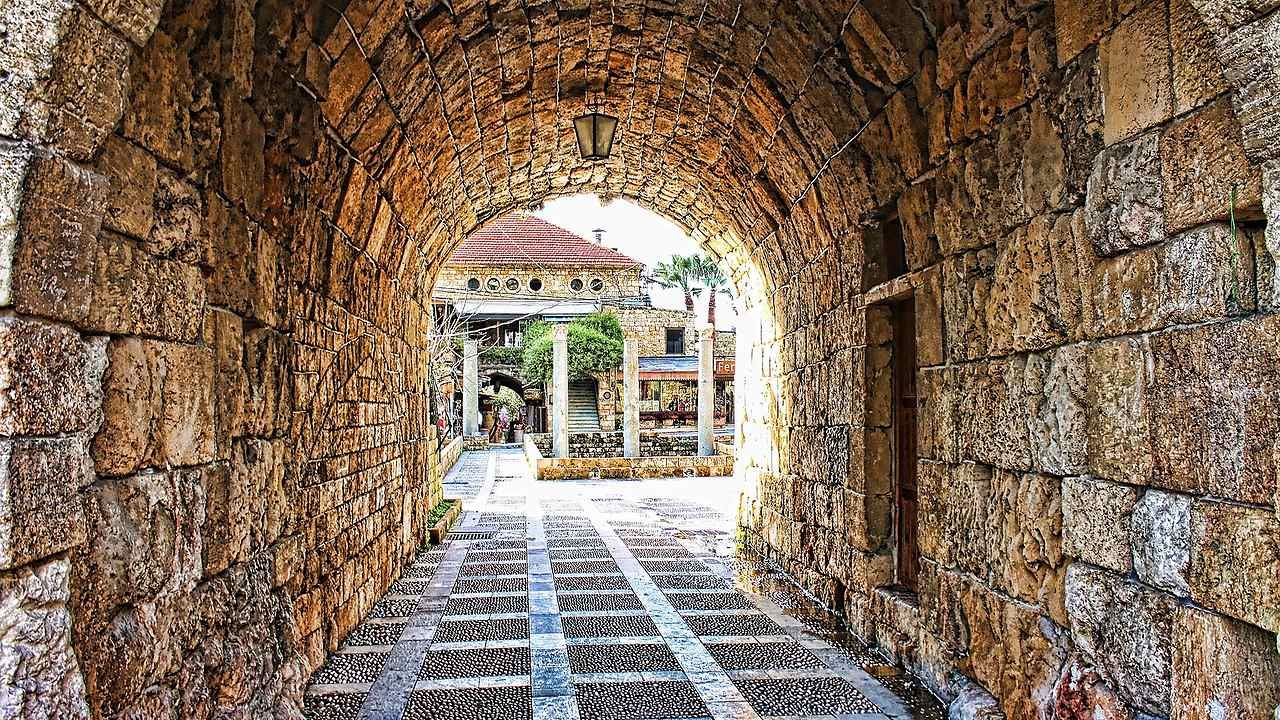 Stone archway and traditional shops in Byblos Old Souk