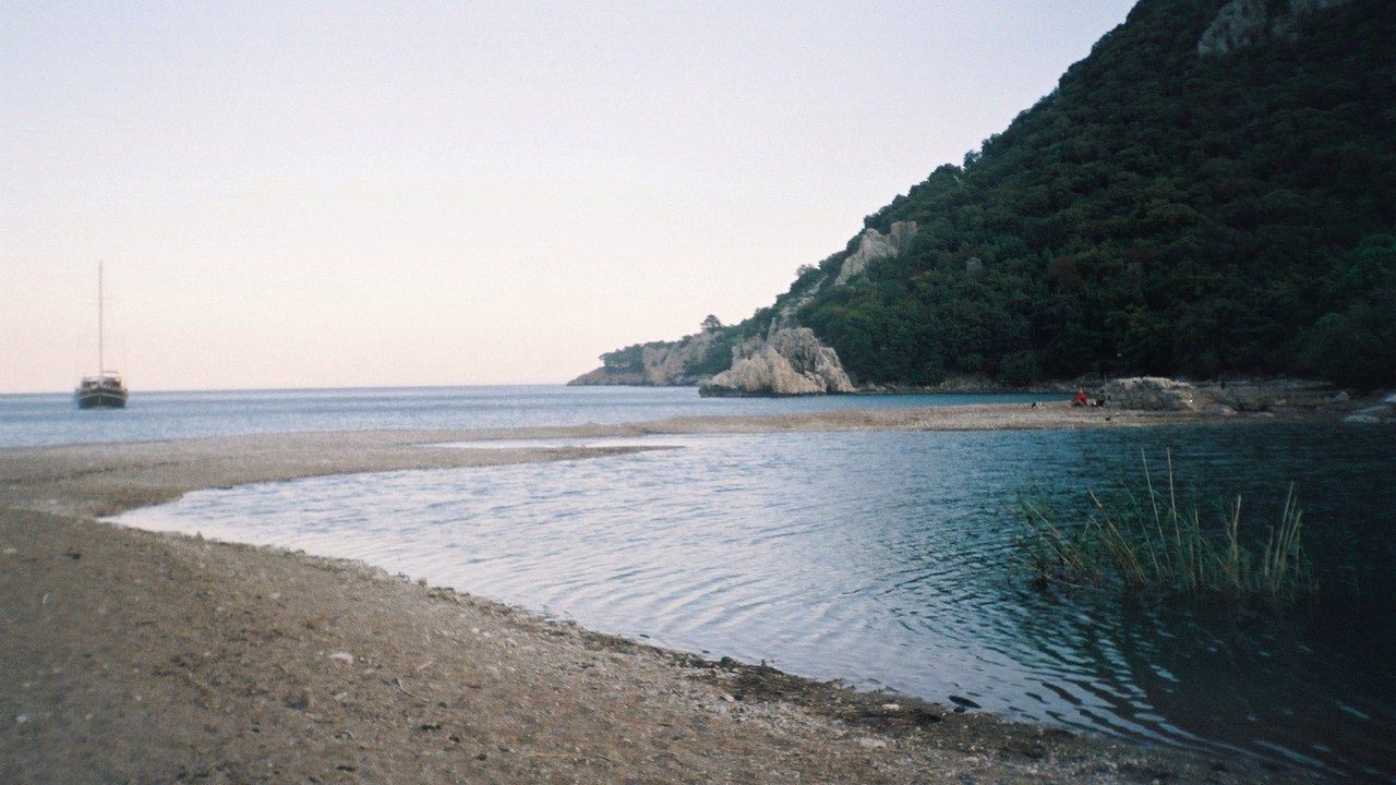 Peaceful coastline and forested mountain at Çıralı Beach in Antalya