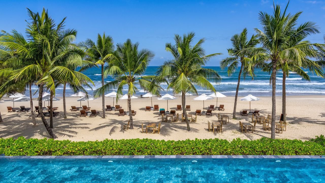 My Khe Beach with palm trees and seaside resort facilities in Da Nang Vietnam