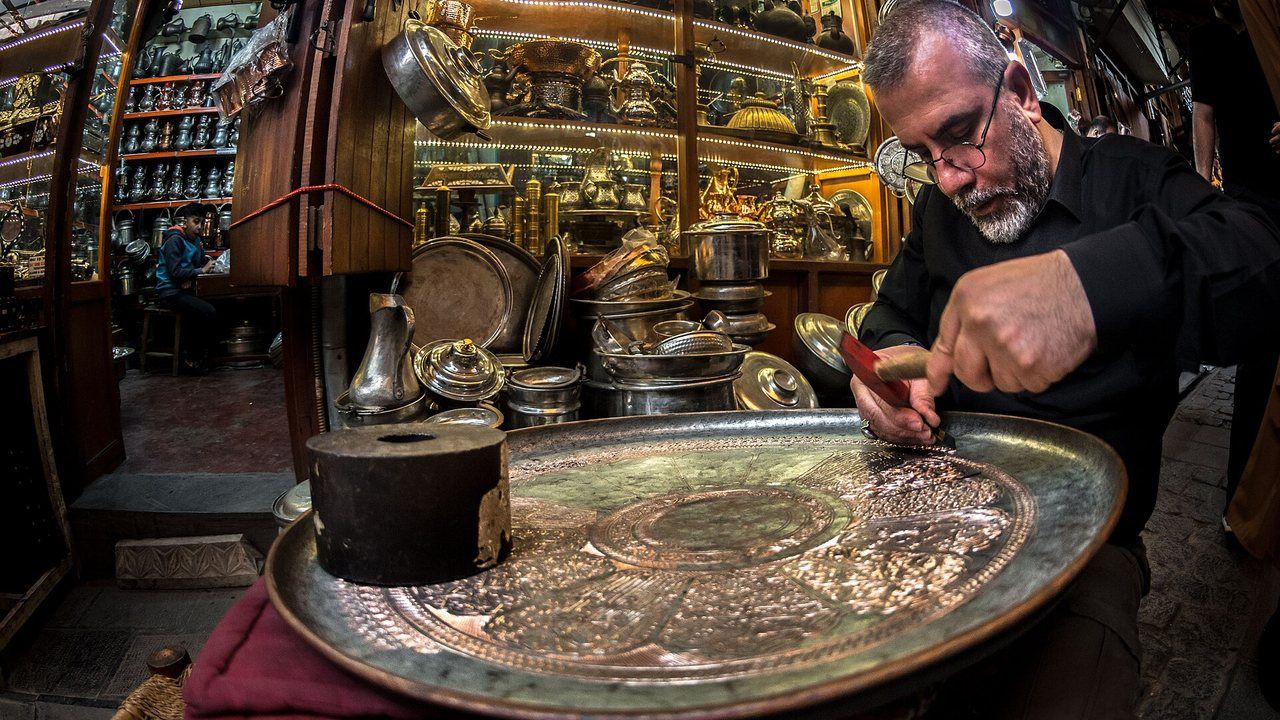 A coppersmith engraving a traditional copper tray in Gaziantep bazaar