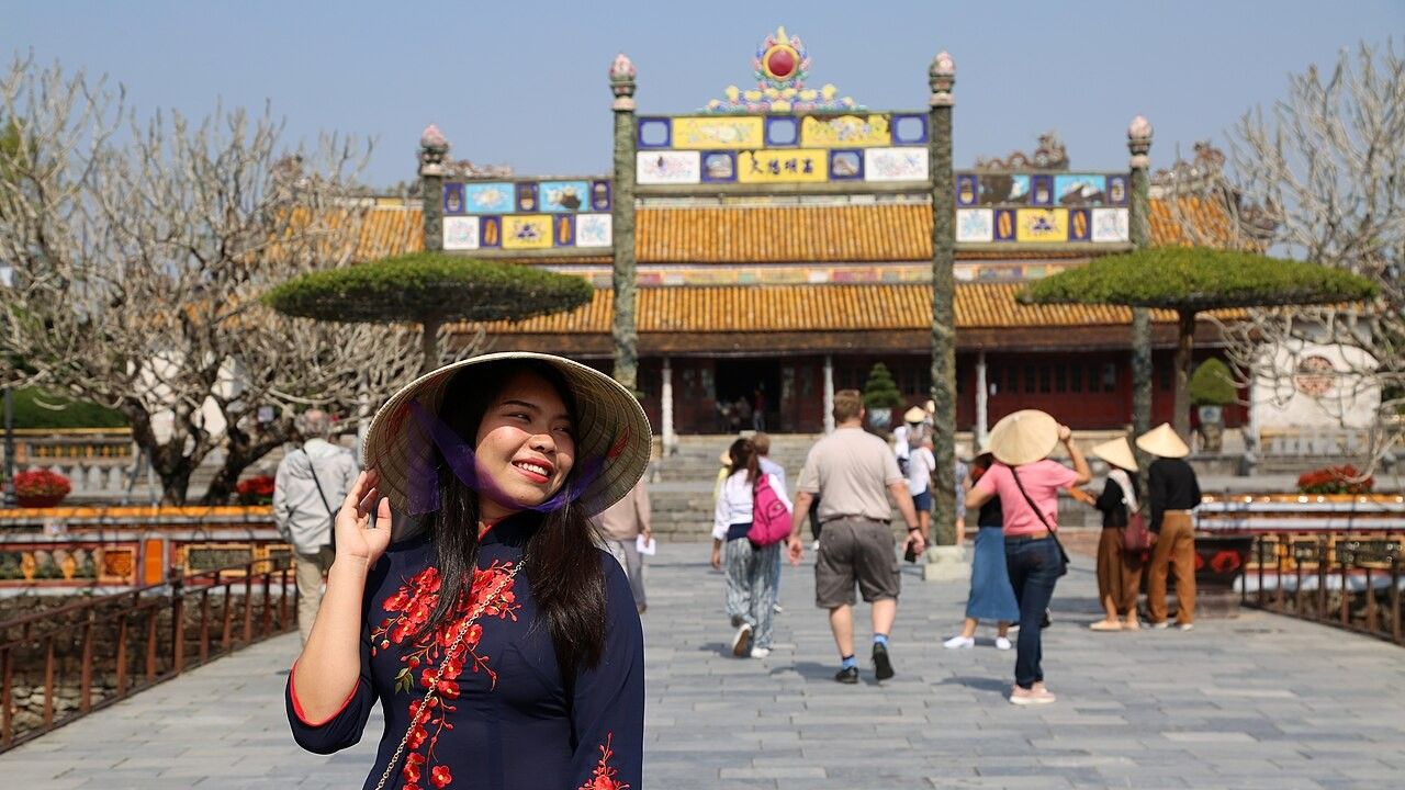 Tourists visiting the historic Imperial City of Hue in Vietnam