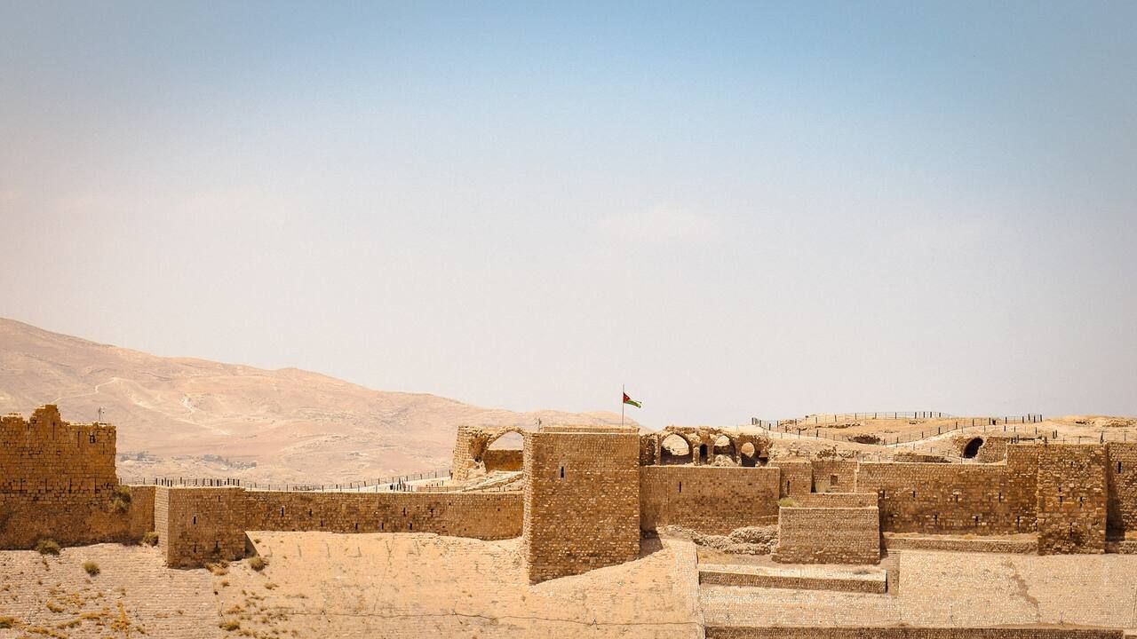 Wide view of the historic Karak Castle and surrounding mountains in Jordan