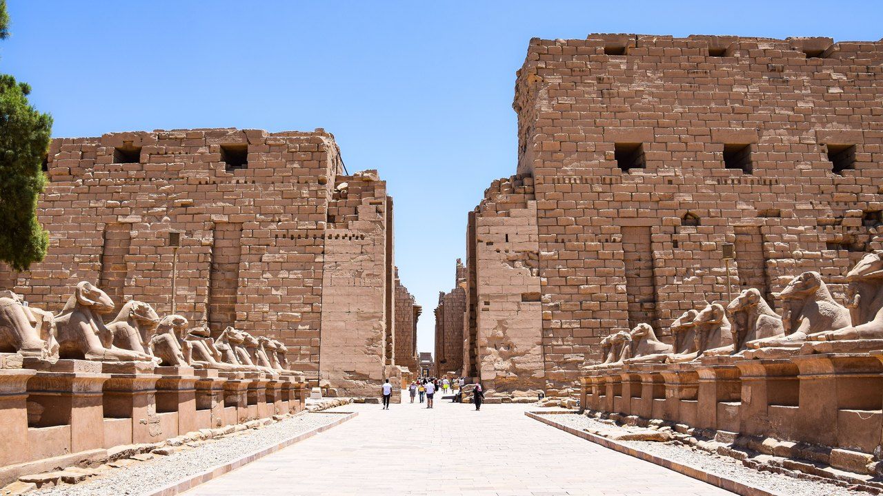 Avenue of sphinxes and ancient pylons at Karnak Temple in Luxor, Egypt
