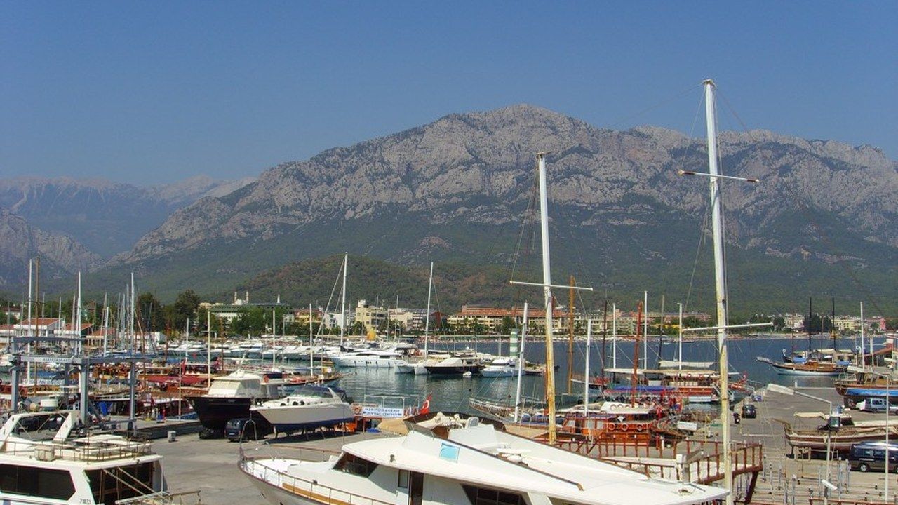 Wide view of Kemer Marina with yachts and the Taurus Mountains