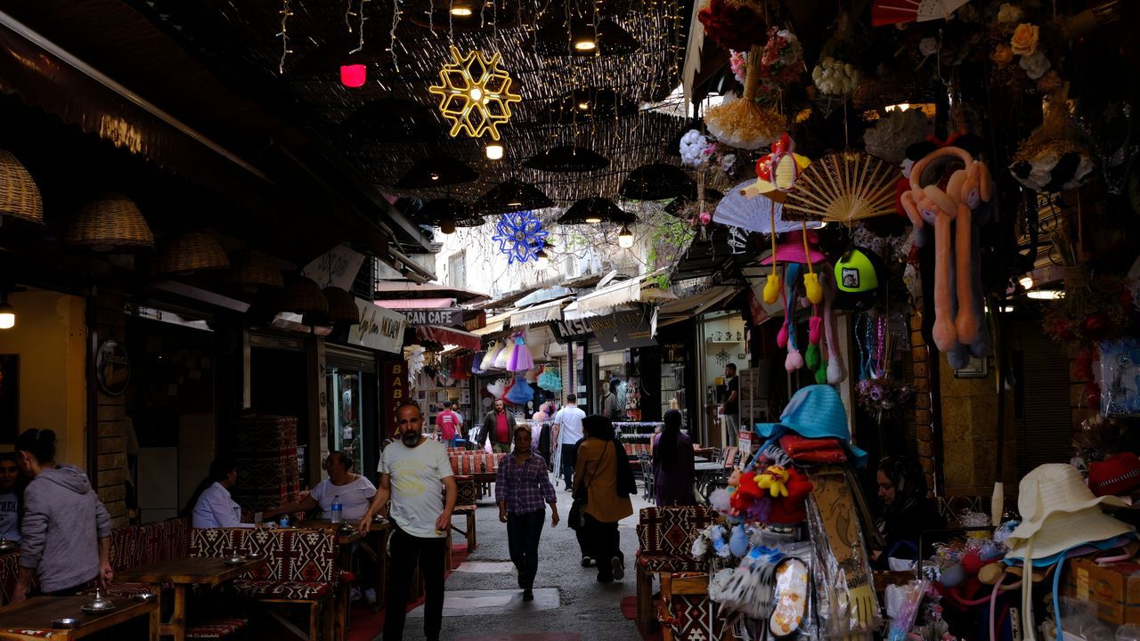 Bustling historic Kemeraltı Bazaar with traditional shops and cafes in Izmir, Turkey.
