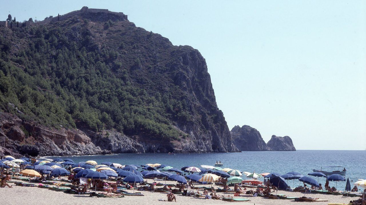 Kleopatra Beach with turquoise water and Alanya Castle in the distance