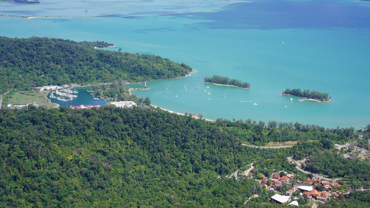 Aerial panoramic view of Langkawi Island with turquoise sea, lush tropical forests and small islands in Malaysia.