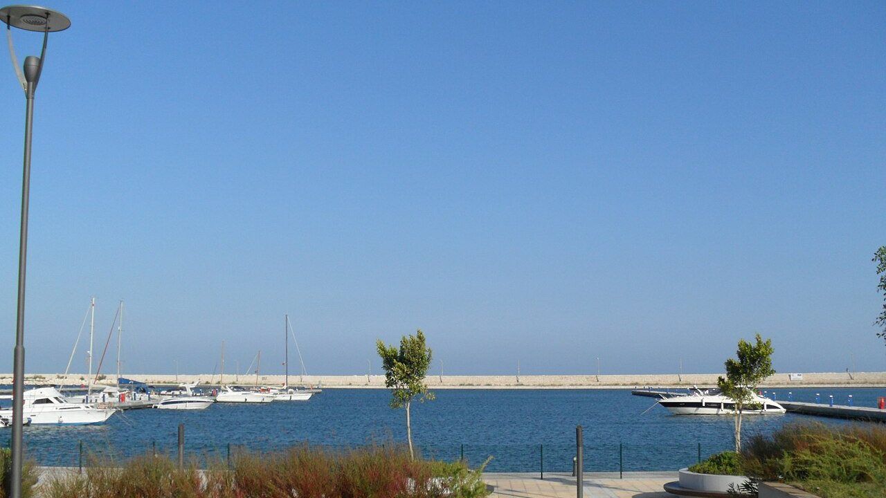 Wide waterfront view of Mersin Marina and yachts on the Mediterranean coast.