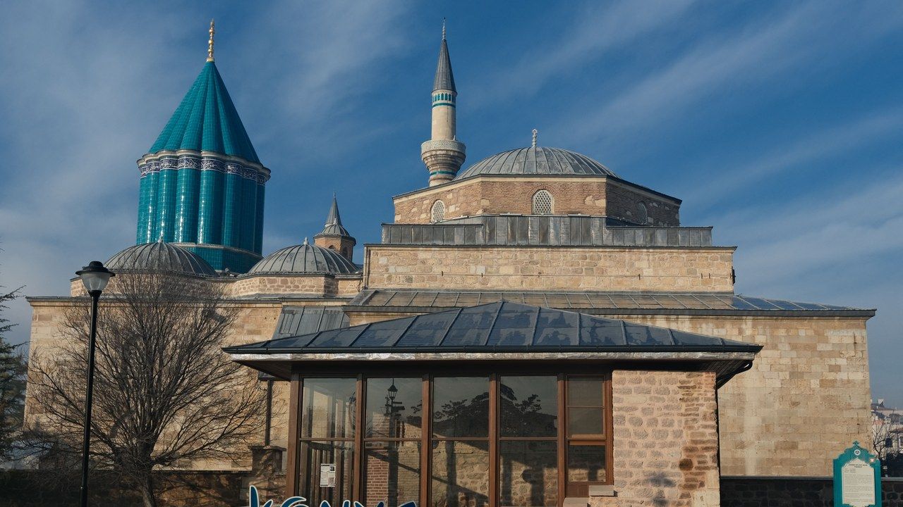 Wide exterior view of Mevlana Museum and its turquoise dome in Konya, Turkey