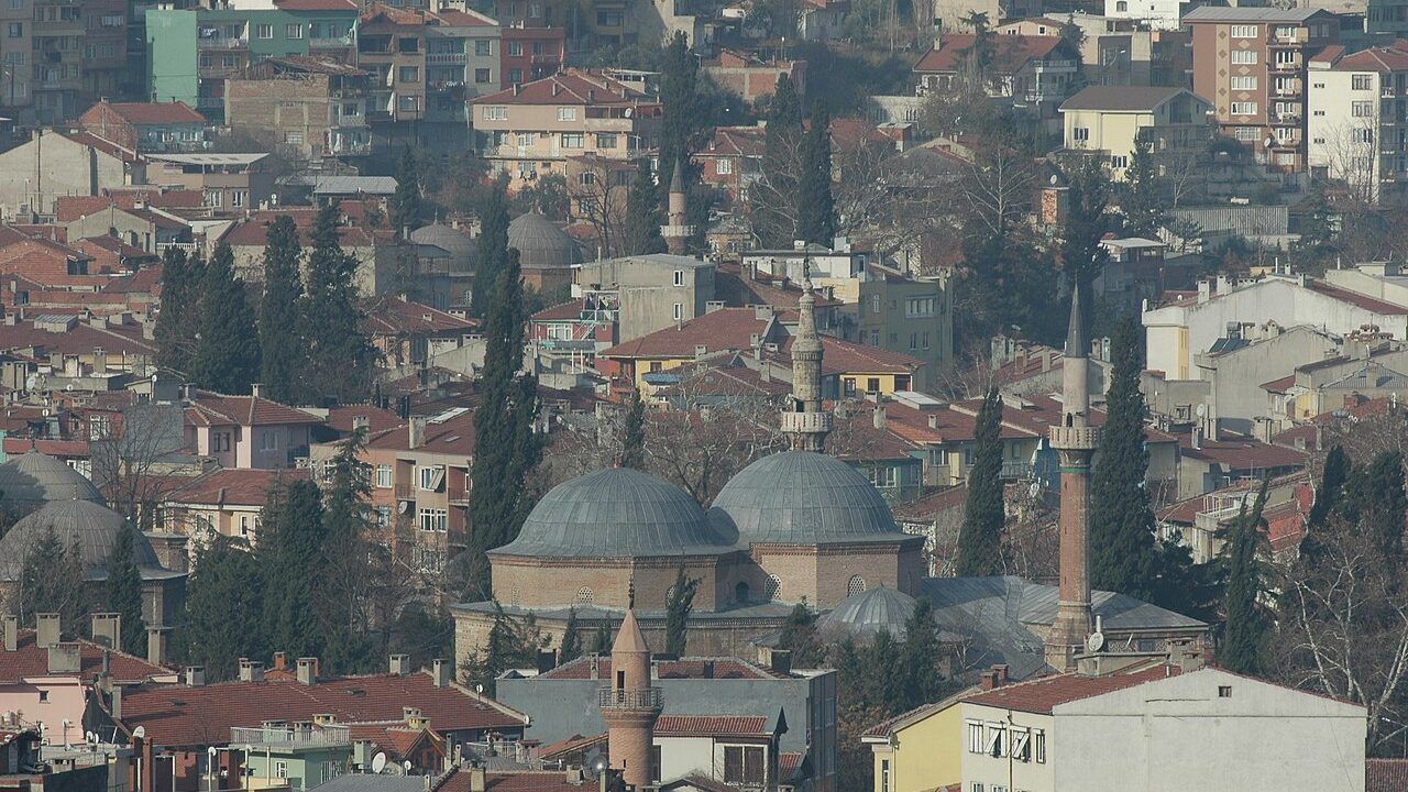 Wide view of the historic Muradiye Complex and mosque surrounded by the cityscape of Bursa, Turkey