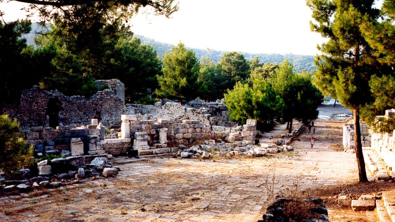 Ancient stone ruins surrounded by pine trees at Phaselis in Antalya