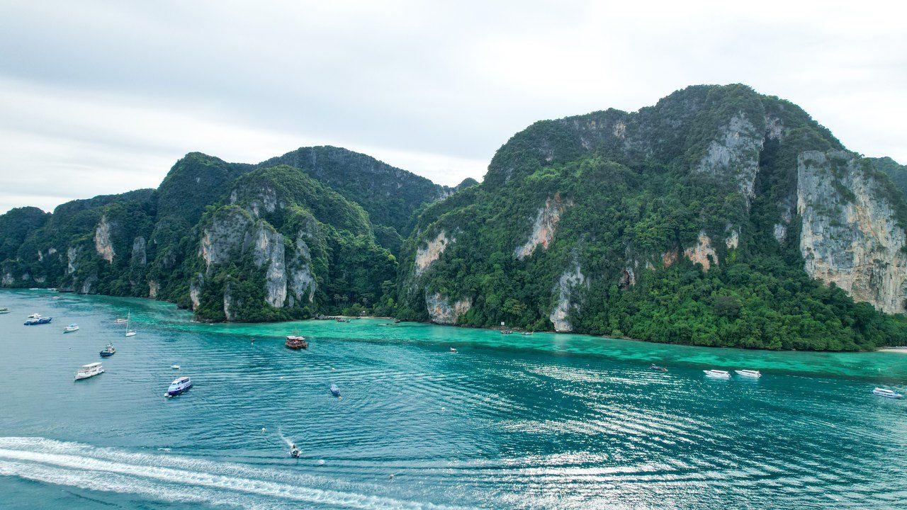 Aerial view of Phi Phi Islands with turquoise water, limestone cliffs and boats in Thailand