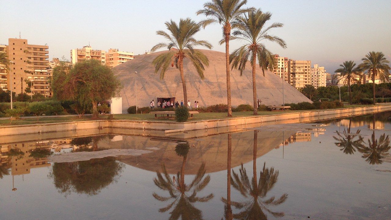 Modernist dome reflected in water at the Rachid Karami International Fair in Tripoli
