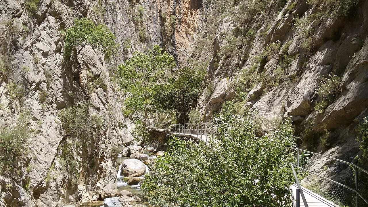 Wooden walkway through the dramatic cliffs and clear water of Sapadere Canyon