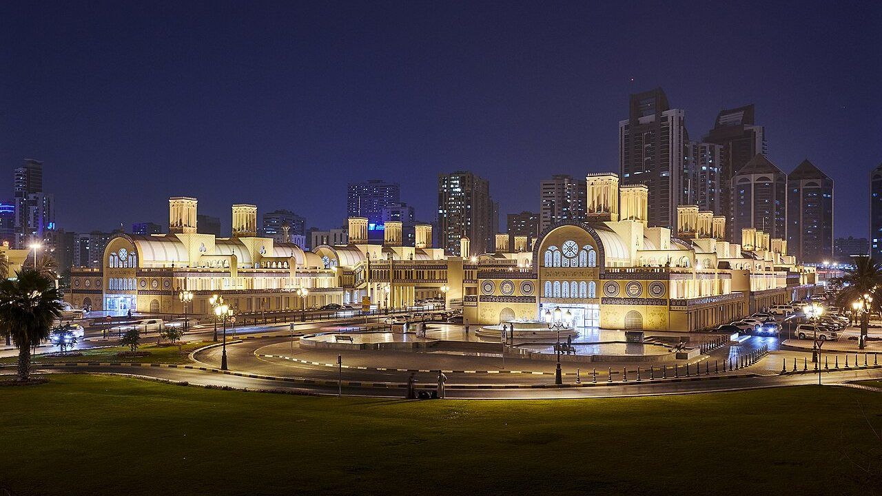 Sharjah Blue Souk Central Market illuminated at night with traditional architecture and blue tile details