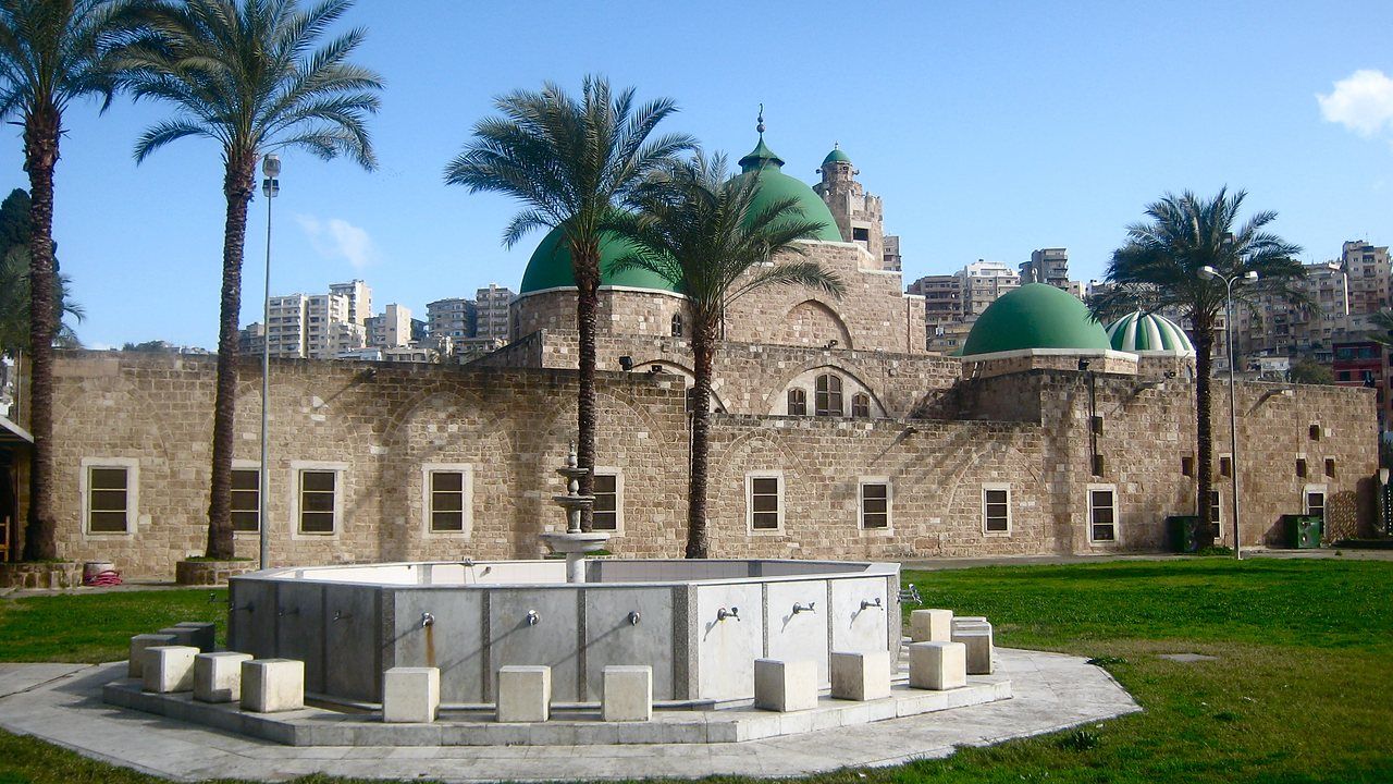 Exterior view of Taynal Mosque surrounded by palm trees in Tripoli, Lebanon