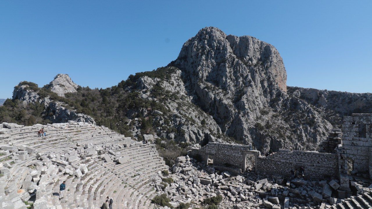 Wide view of Termessos ancient city amphitheater surrounded by mountains in Antalya, Turkey