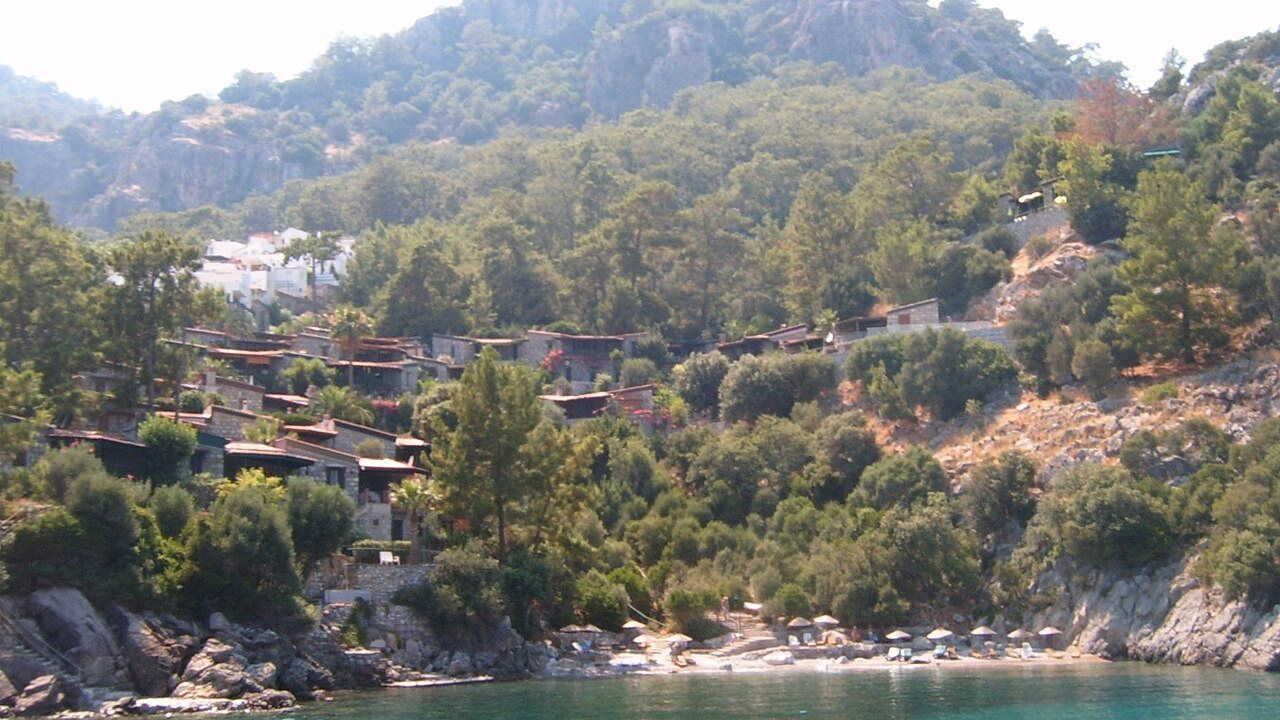 Scenic coastal bay surrounded by green mountains in Turunc near Marmaris.