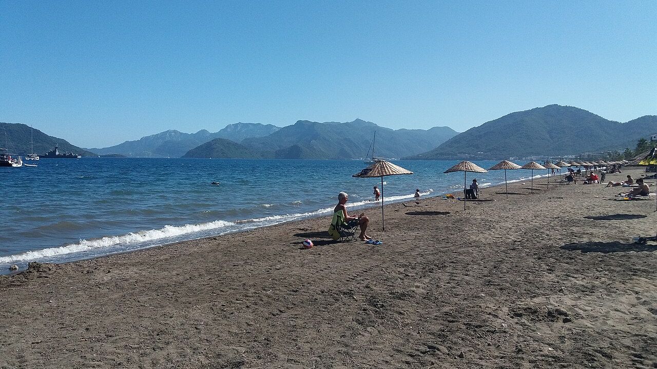 Wide coastal view of Uzunyali Beach and the surrounding mountains in Marmaris.