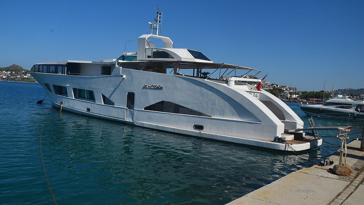 Luxury yacht moored in the clear blue water of Yalikavak Marina